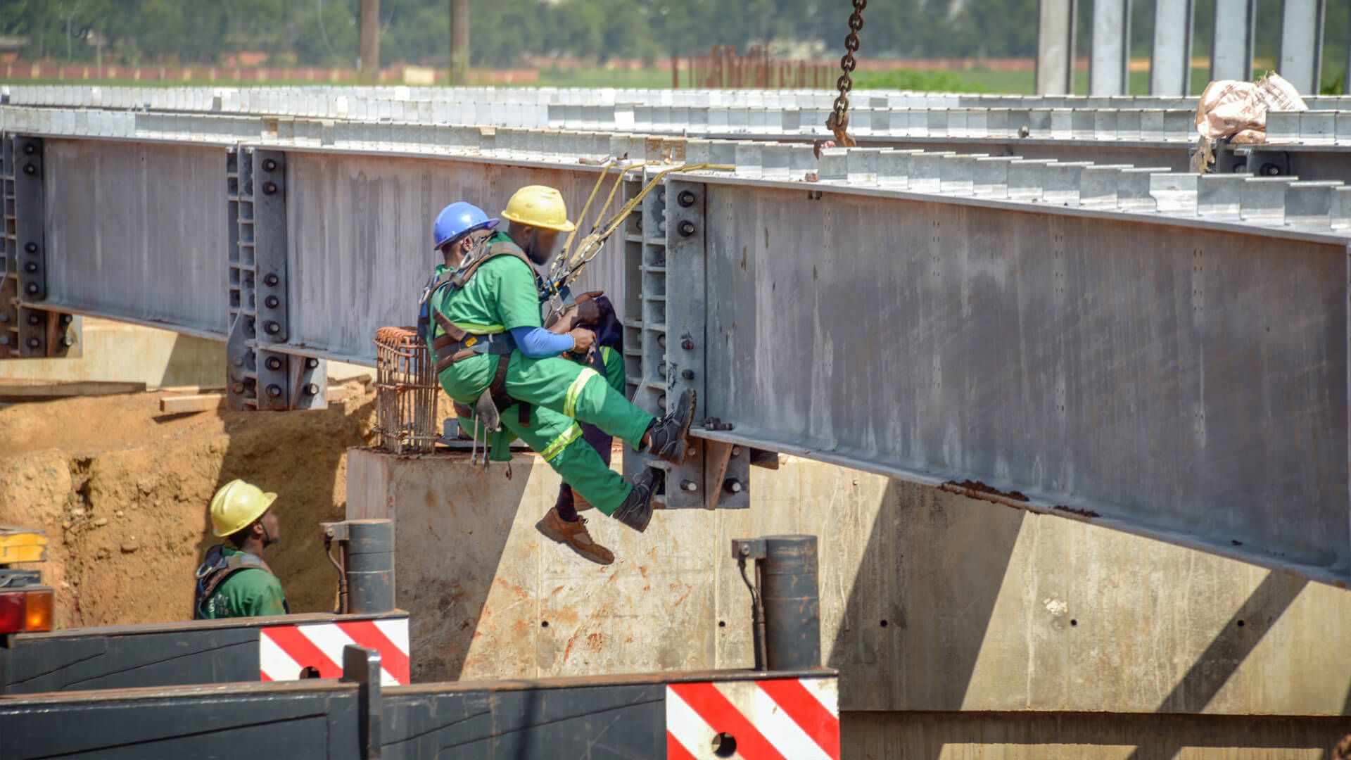 A group of construction workers are working on a bridge.