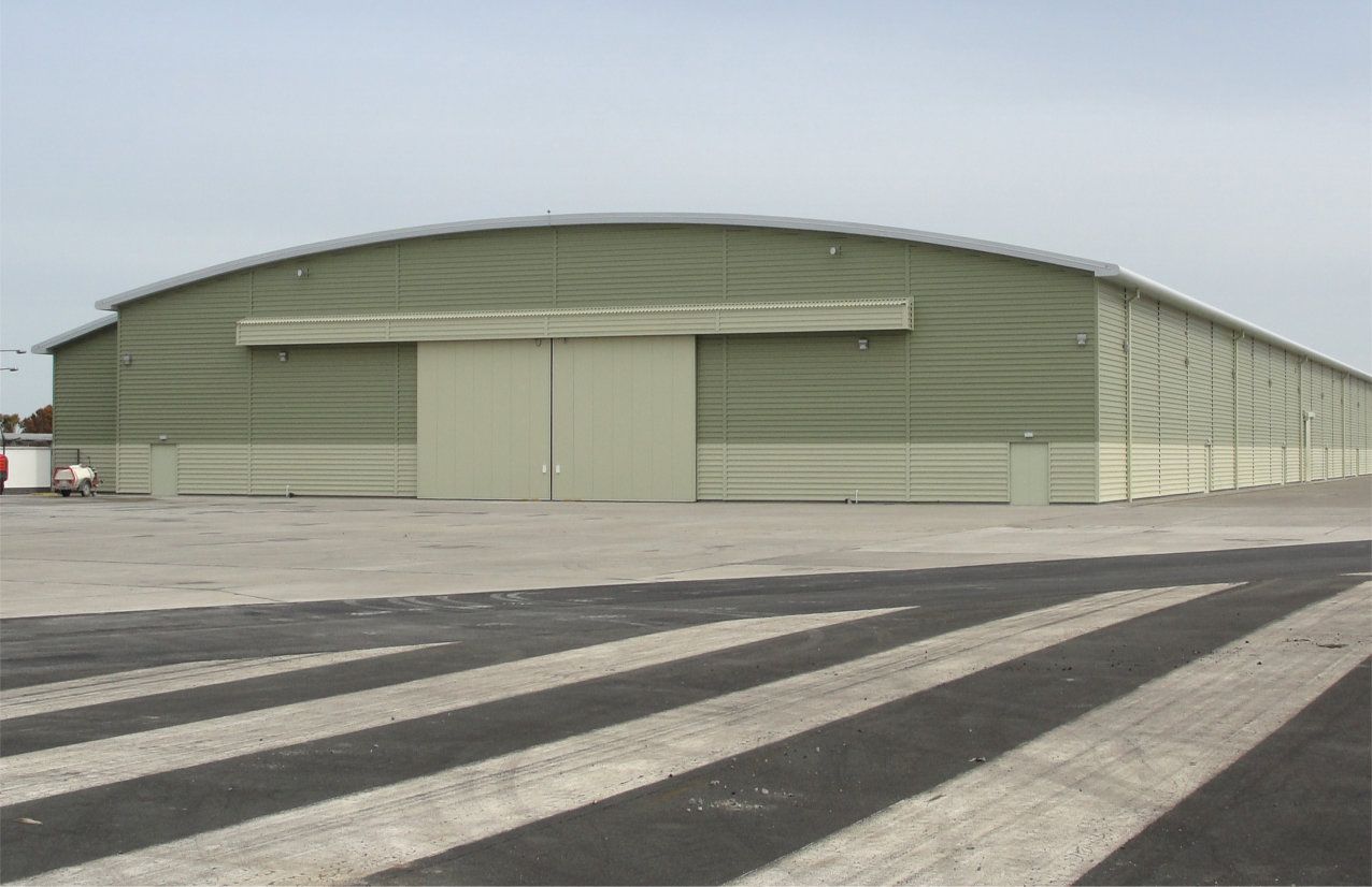 A large green building with a large sliding door