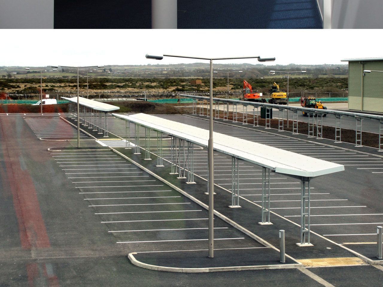 An artist 's impression of a parking lot with a building in the background
