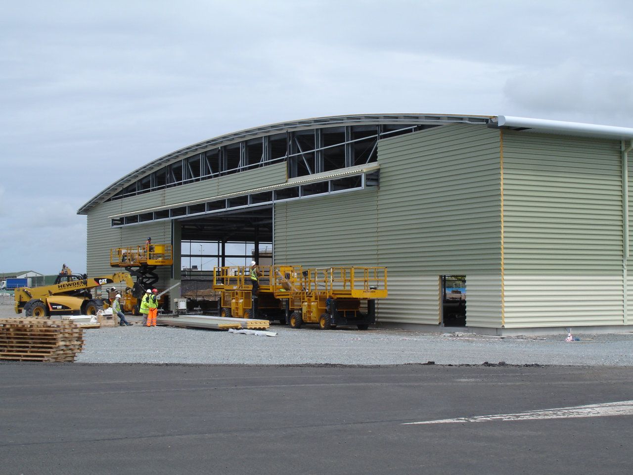 A large building with a lot of machinery in front of it