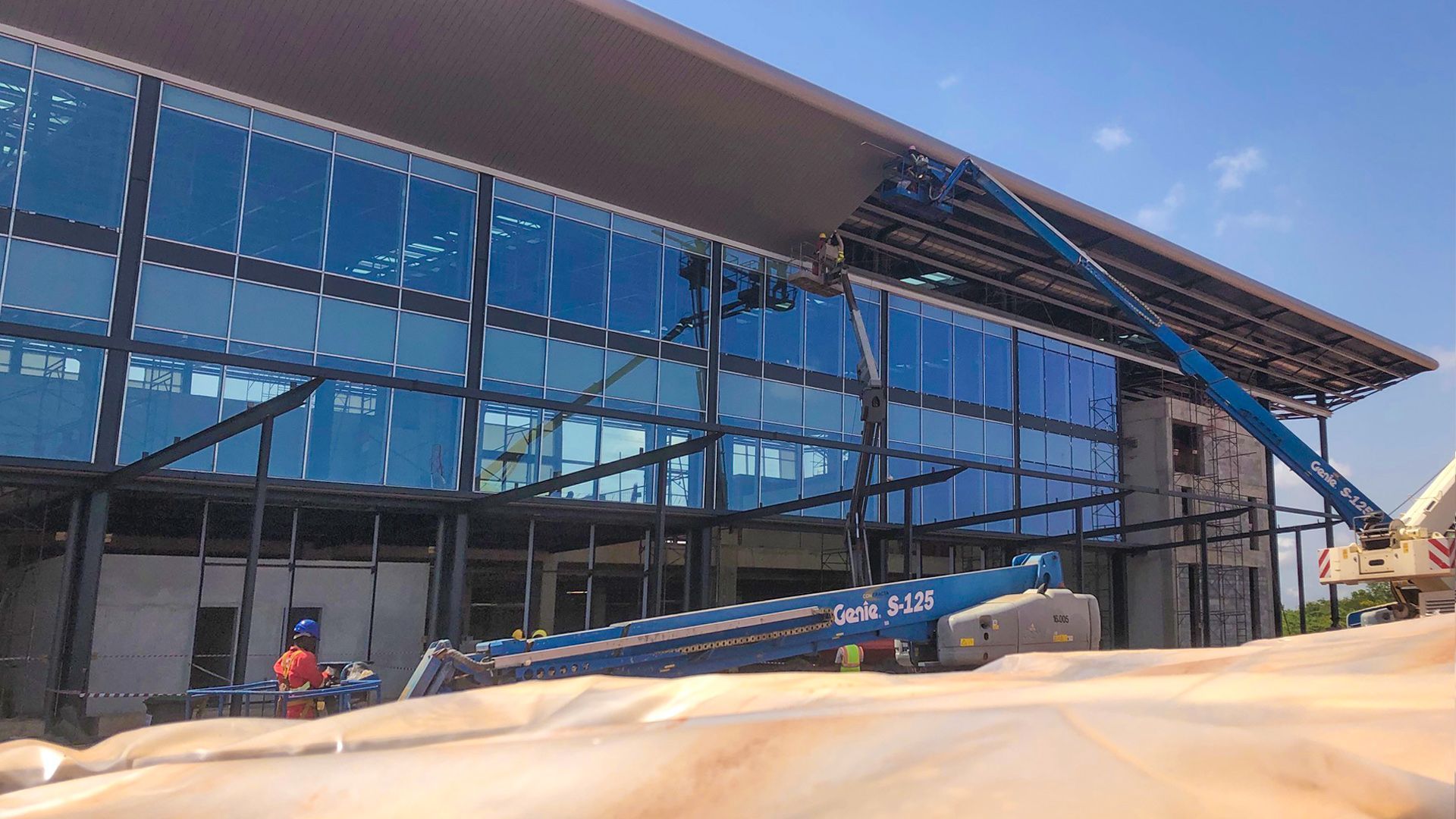 A large building with a lot of windows is being built.