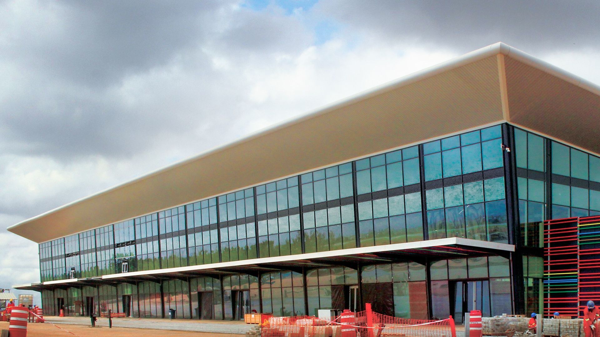 A large building with a lot of windows is under construction.