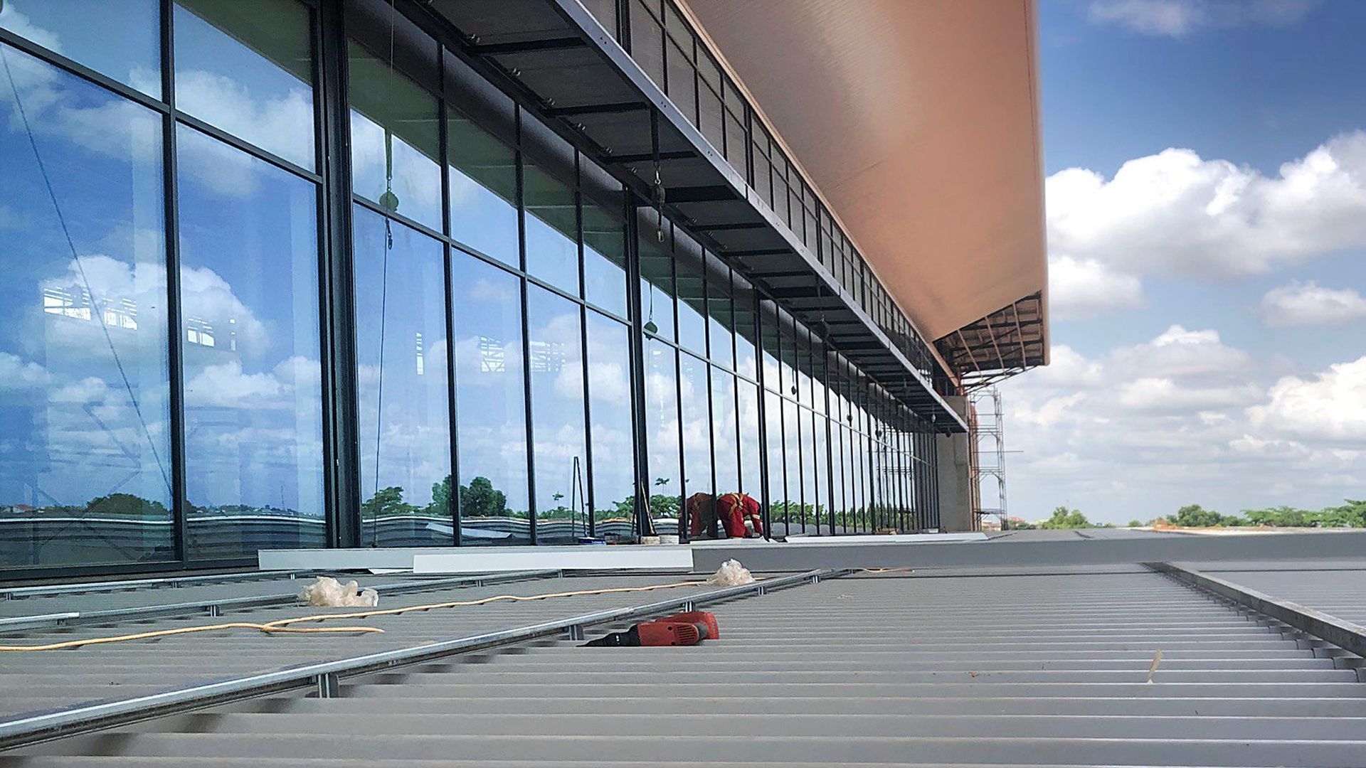 A large building with a lot of windows is being built.