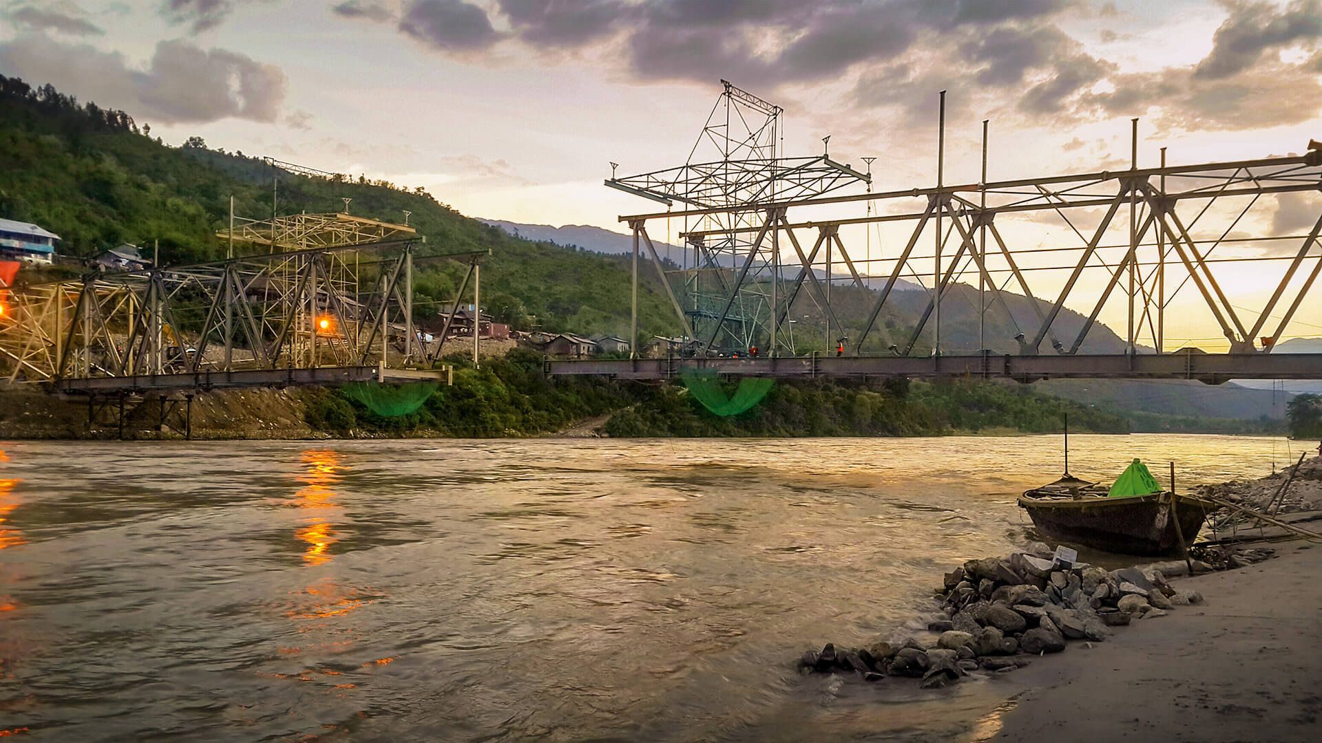 A river with a bridge in the background and a boat in the foreground