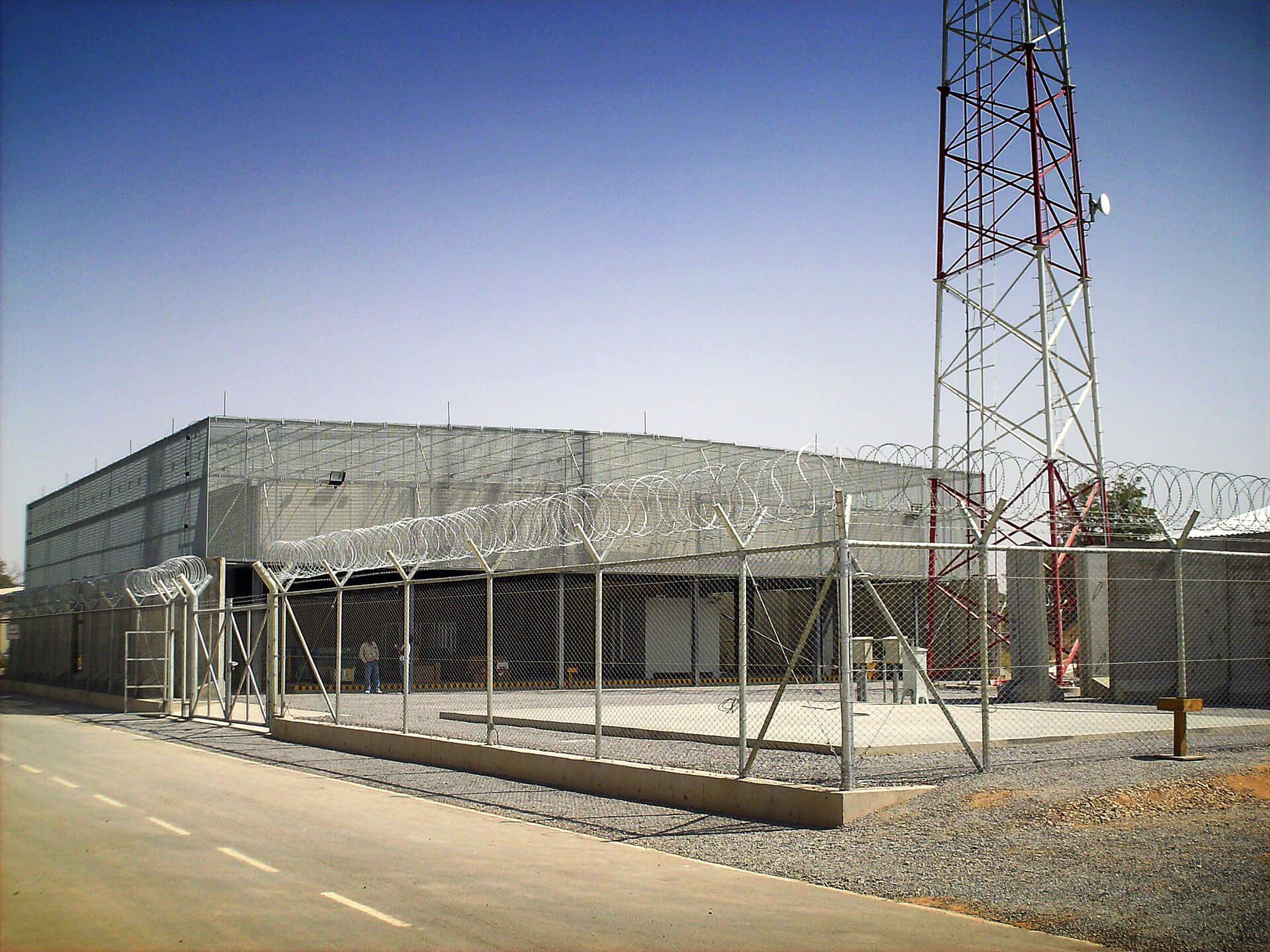 A building with a barbed wire fence around it