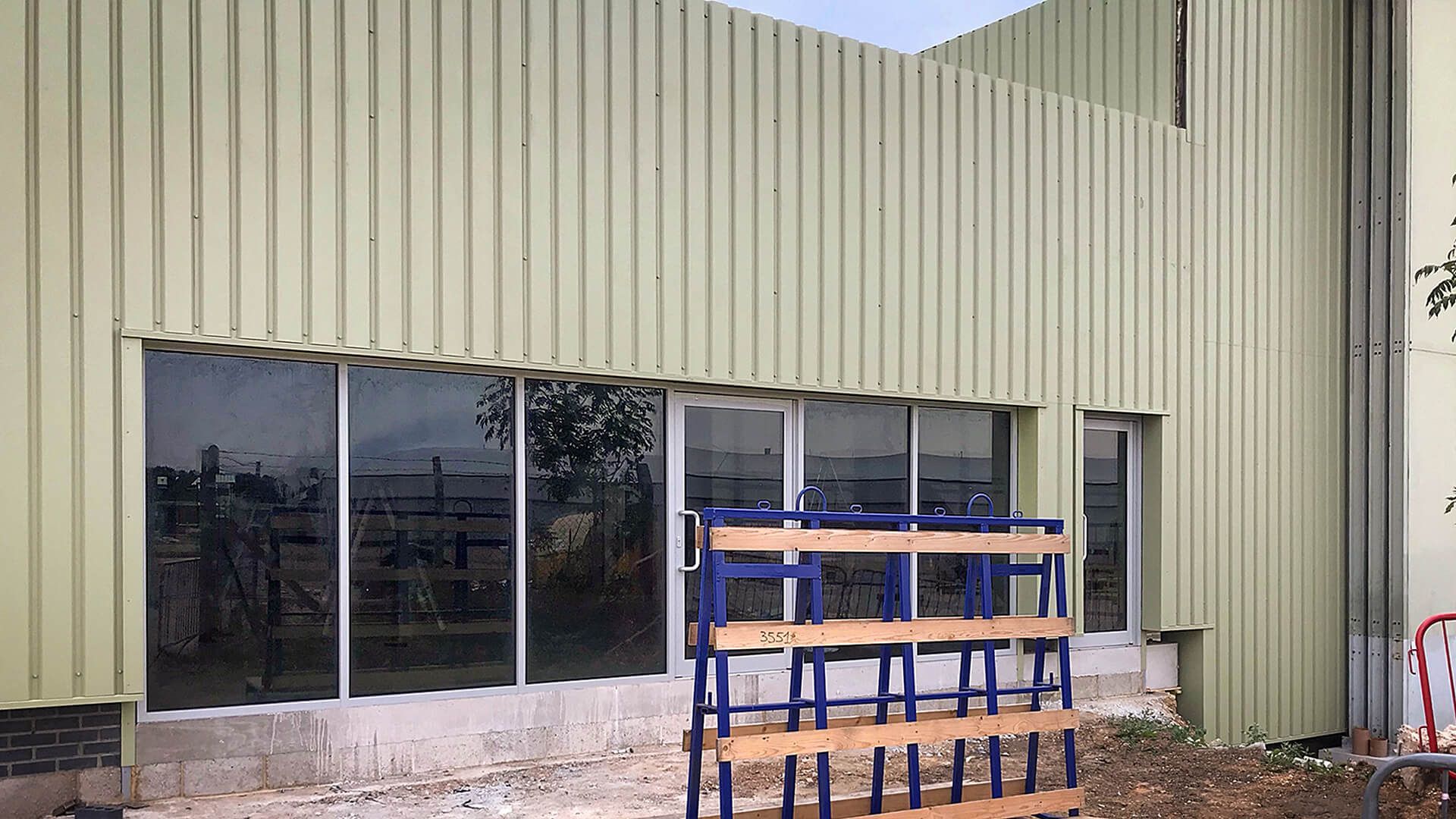 A large building with a lot of windows and a wooden pallet in front of it.