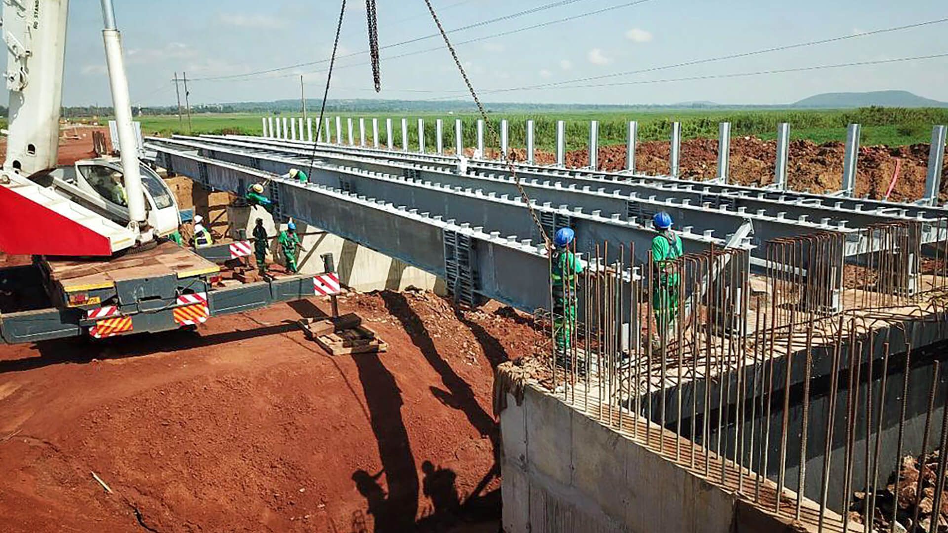A group of construction workers are working on a bridge.