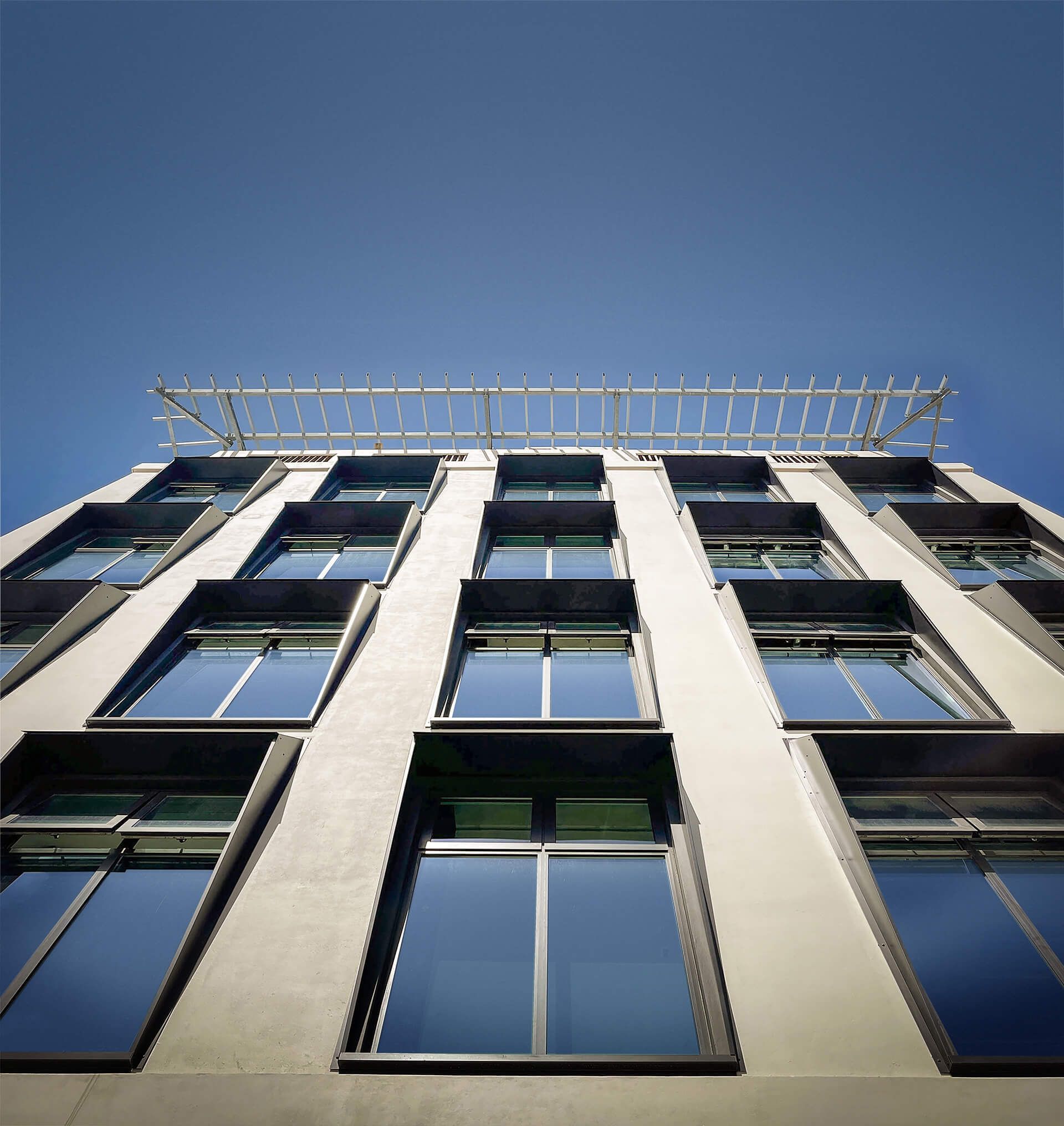 Looking up at a tall building with lots of windows