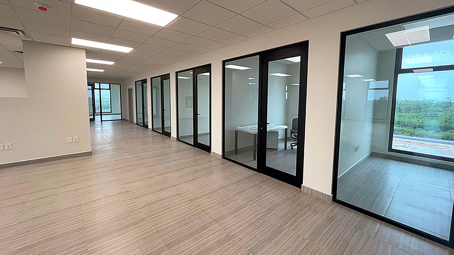 An empty office building with a lot of windows and doors.