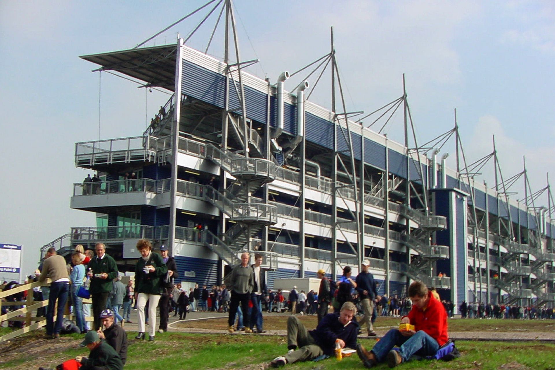 A group of people are sitting in front of a large building