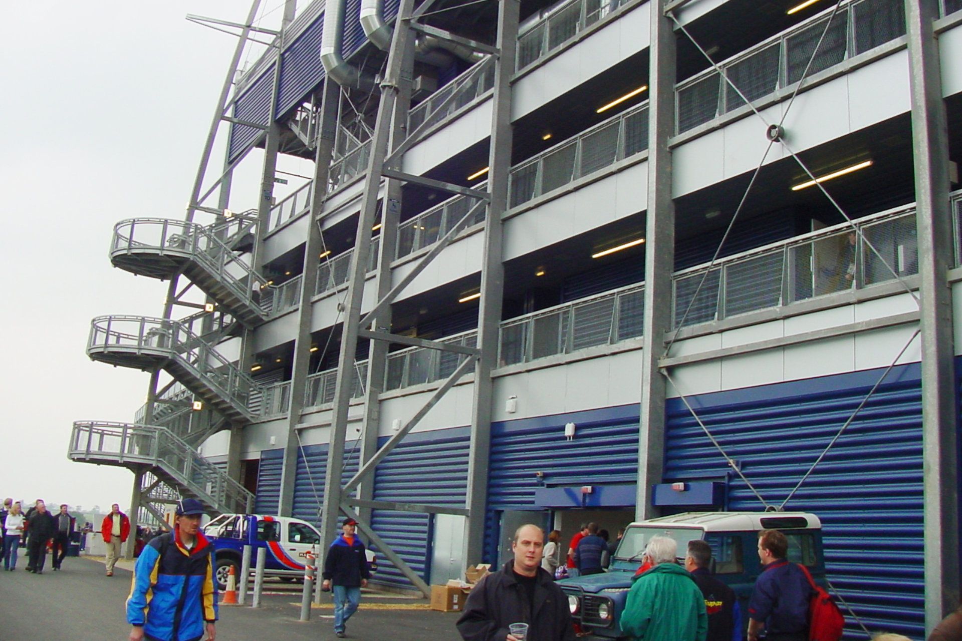 A group of people standing outside of a building with stairs