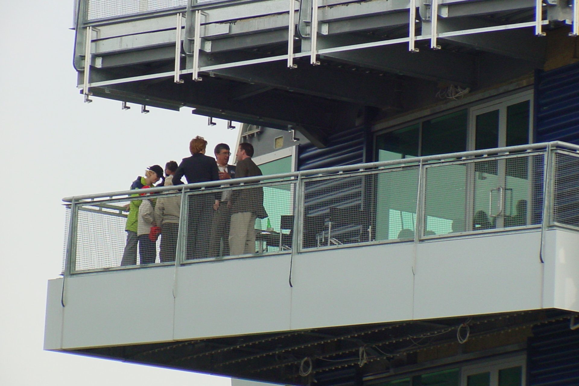 A group of people standing on top of a balcony