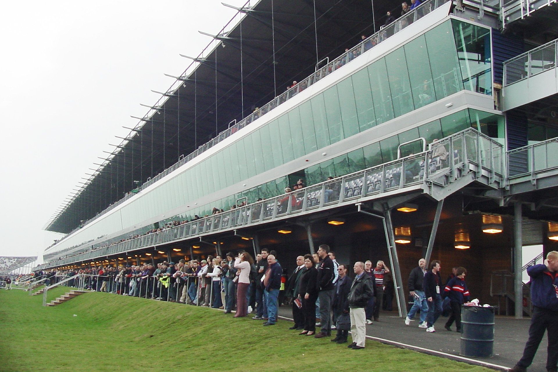 A group of people are standing in front of a stadium