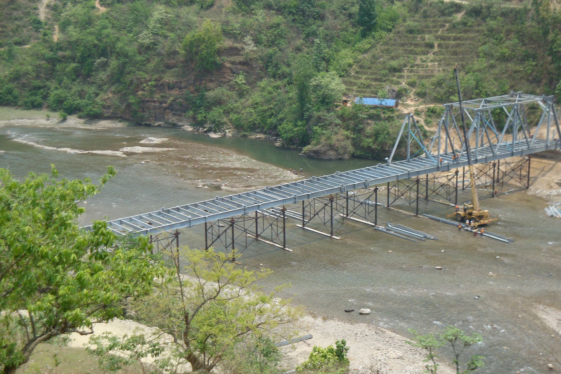A bridge over a river with trees in the background