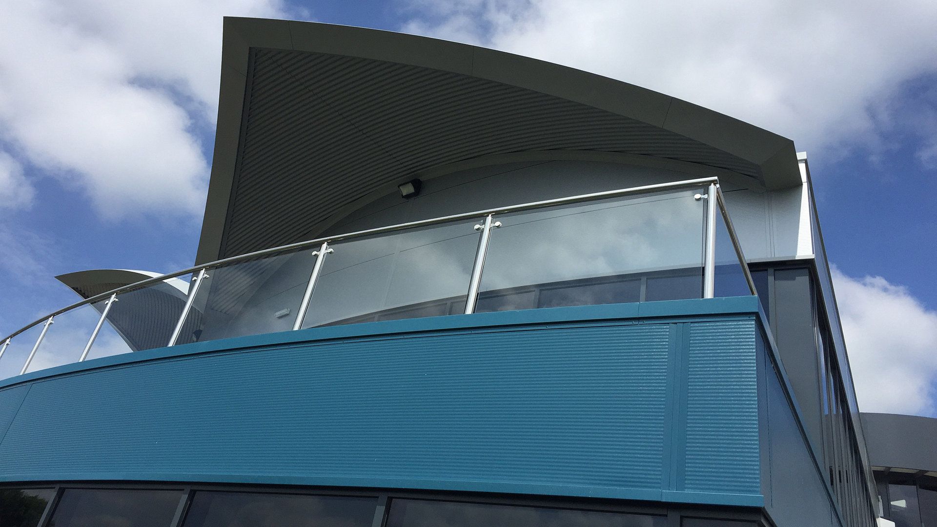A building with a balcony on the top of it.