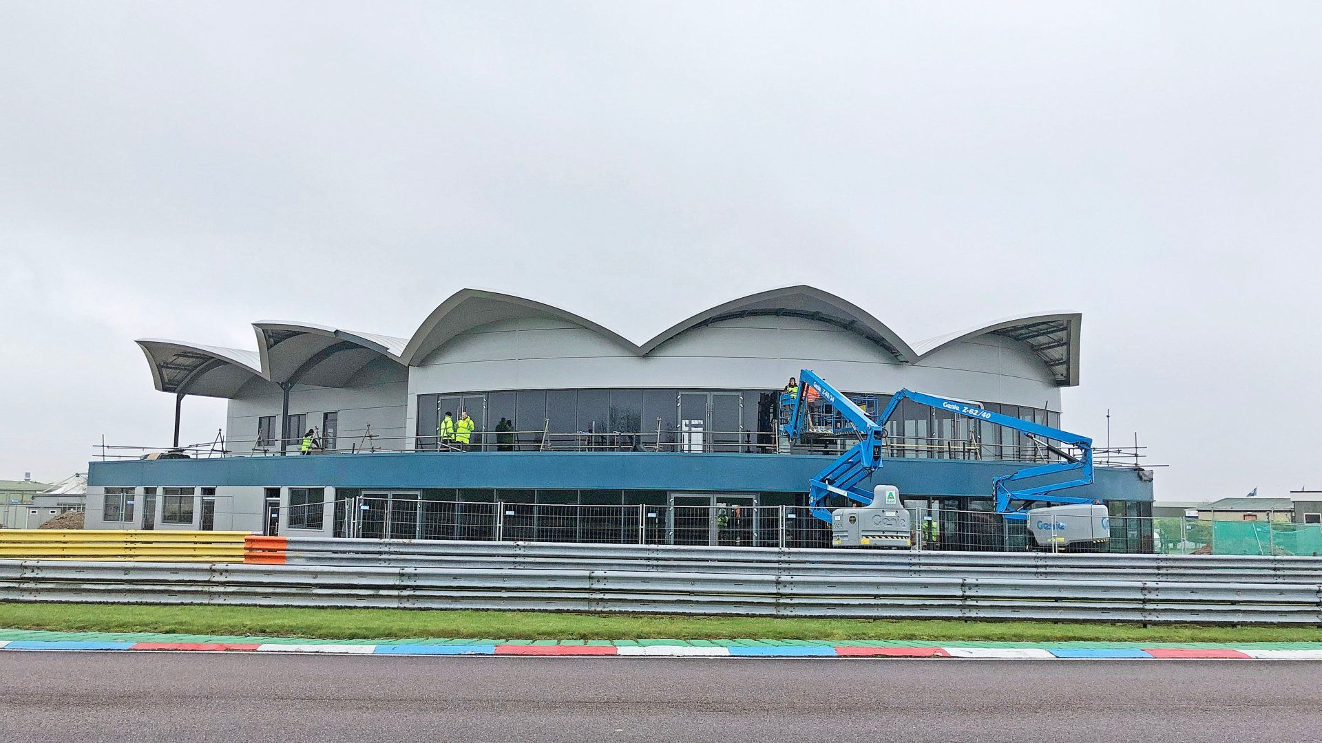 A large building is being built on a race track.