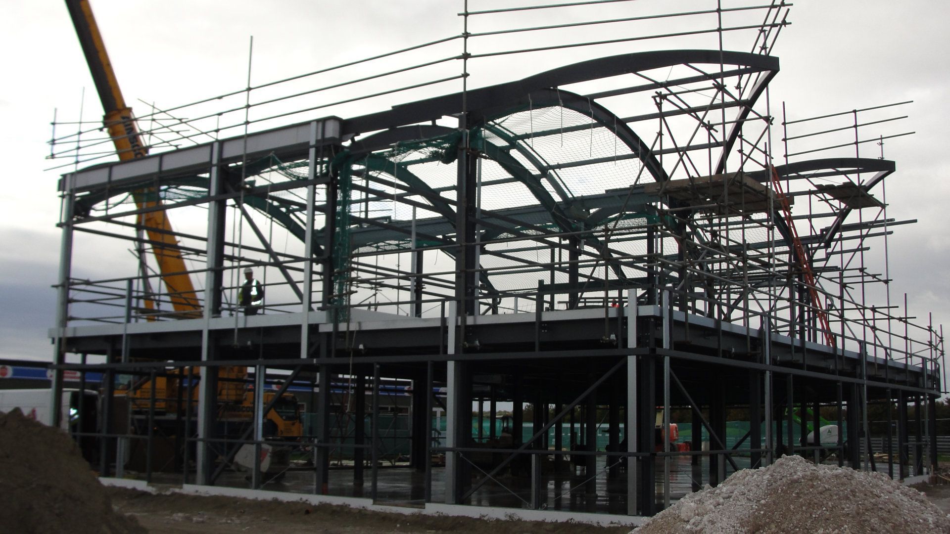 A large building under construction with a crane in the background
