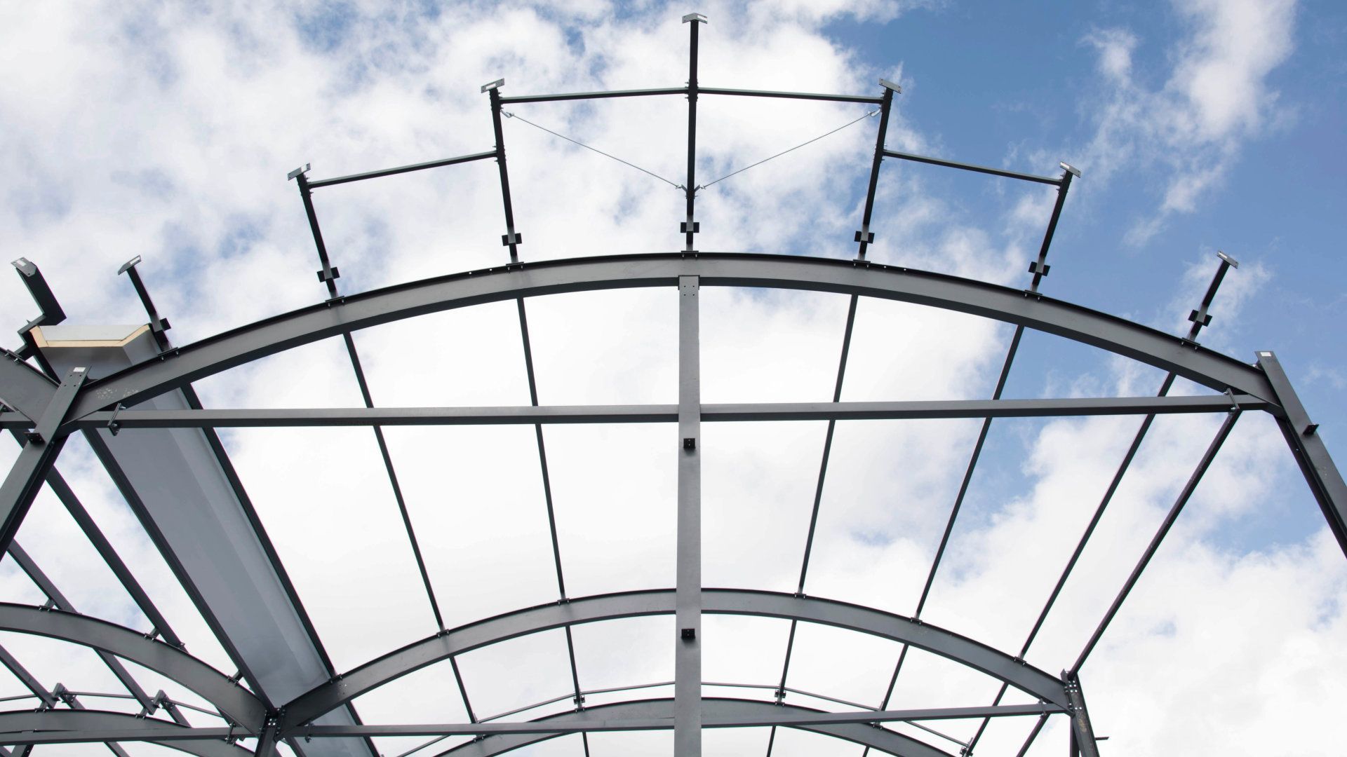 Looking up at a metal structure with a blue sky in the background