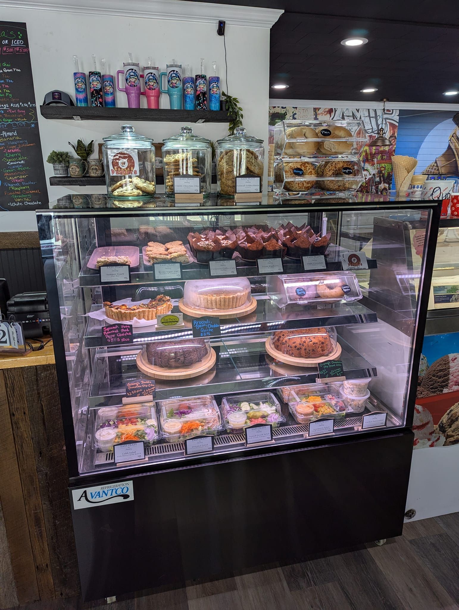 Display case filled with cakes and pastries at a cafe.