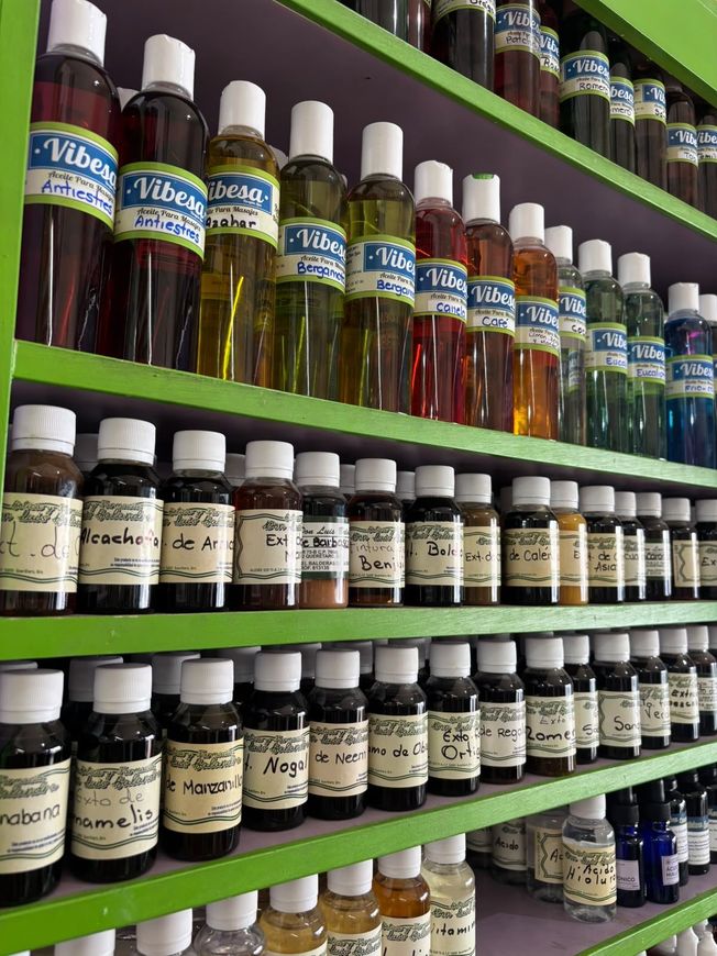 Hay muchas velas y botellas de aceite sobre la mesa.