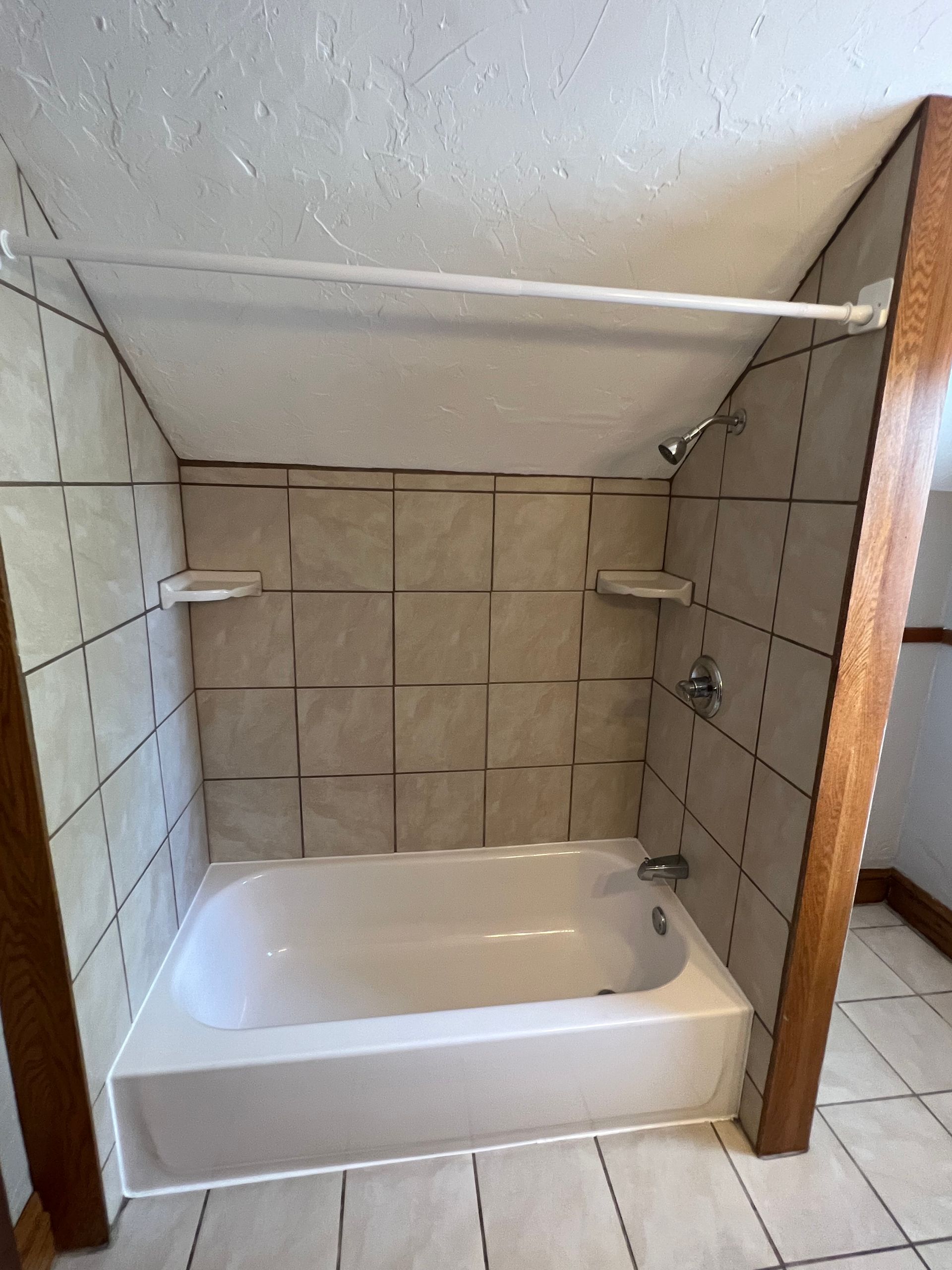 A bathroom with a bathtub and a shower.
