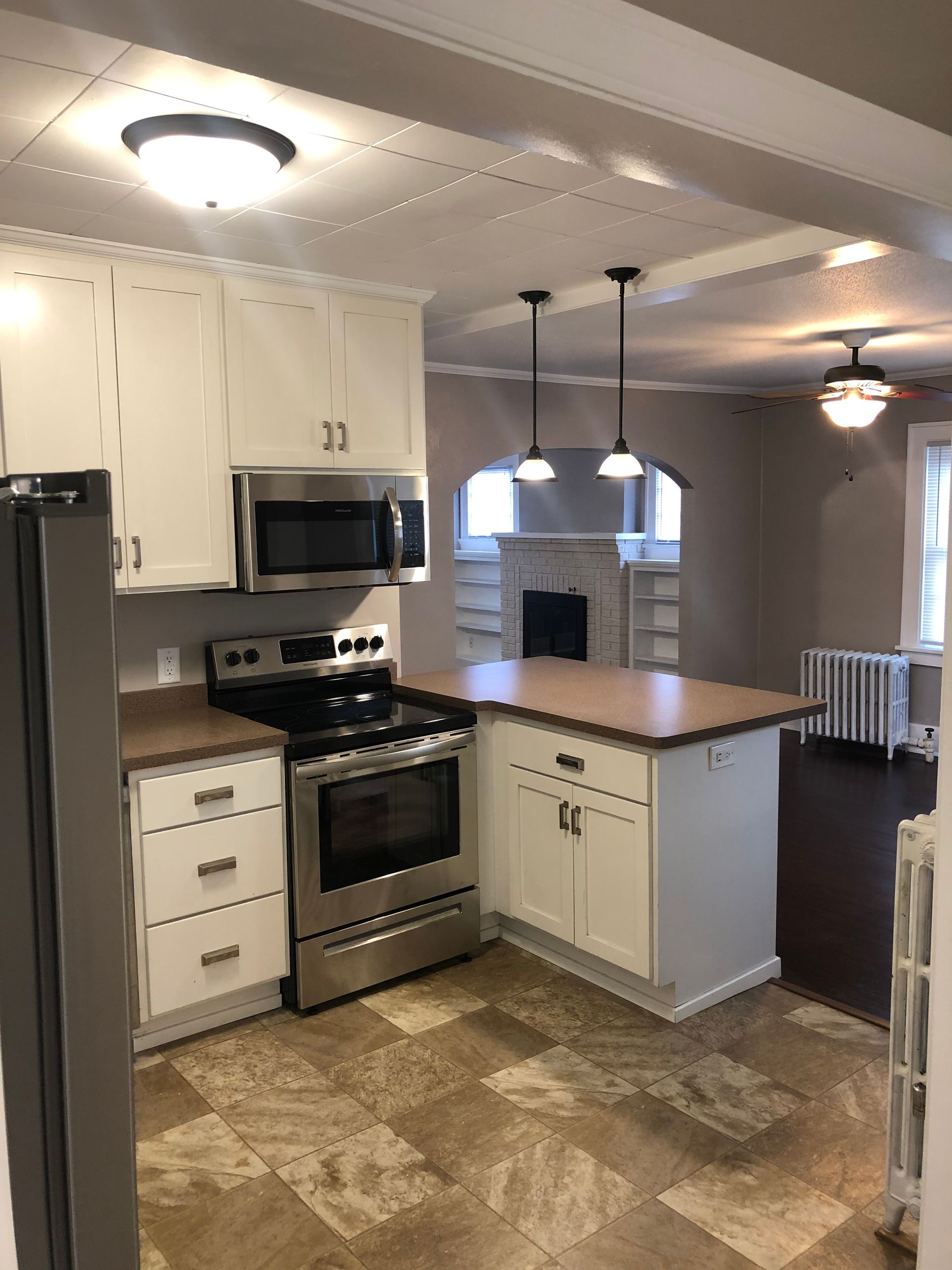 A kitchen with stainless steel appliances and white cabinets