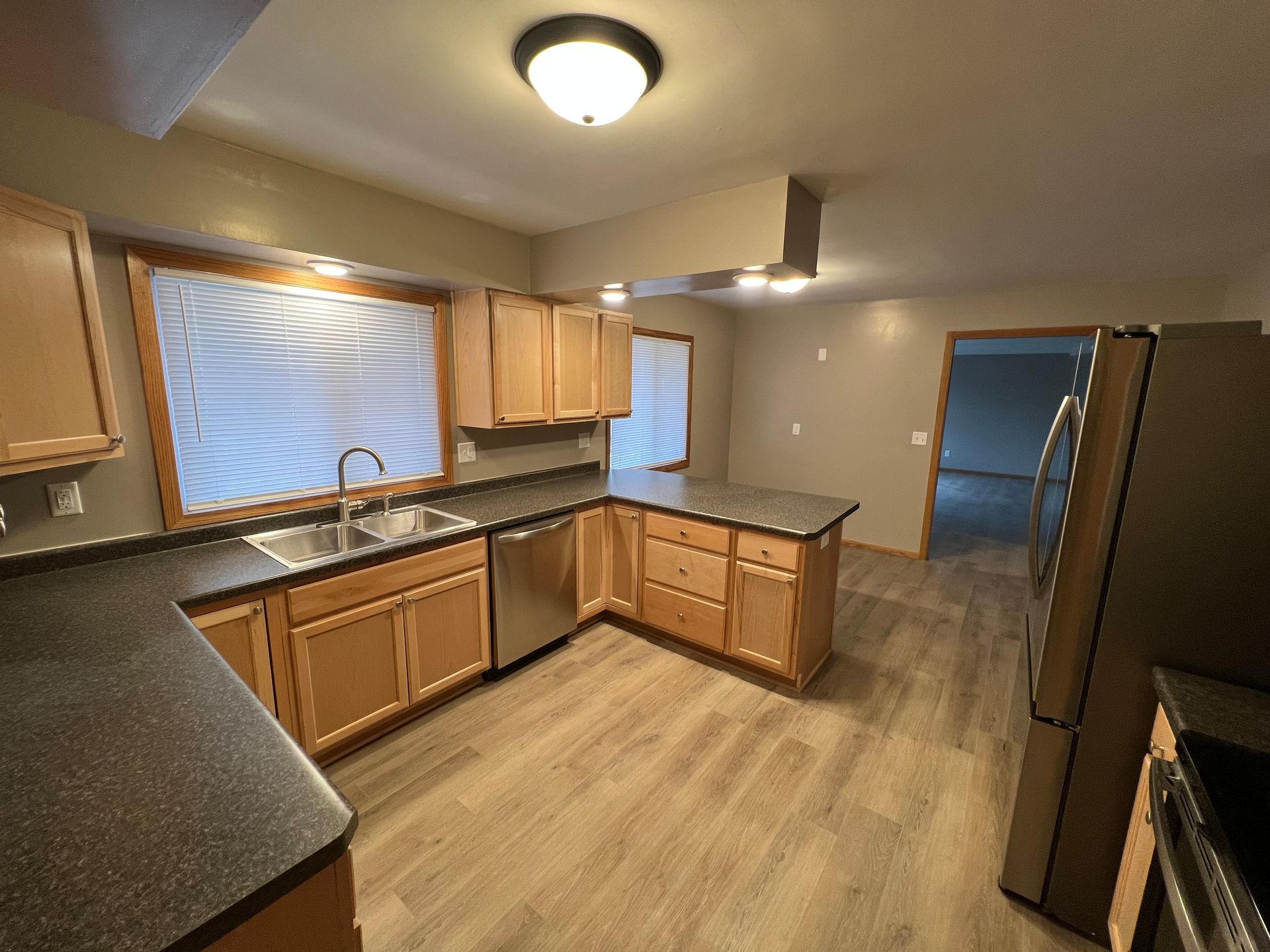 A kitchen with stainless steel appliances and wooden cabinets