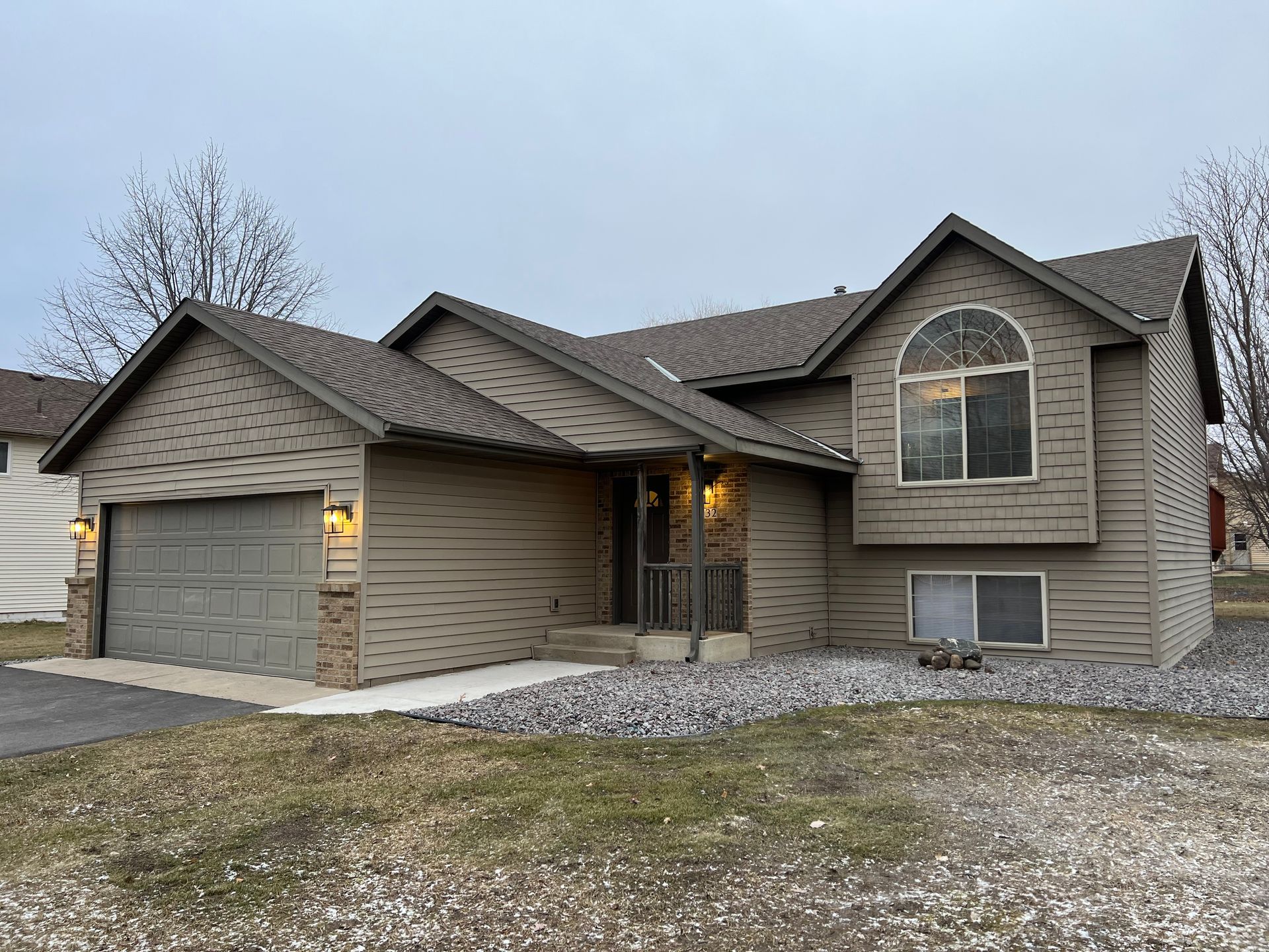 A large house with a large garage and a large window.