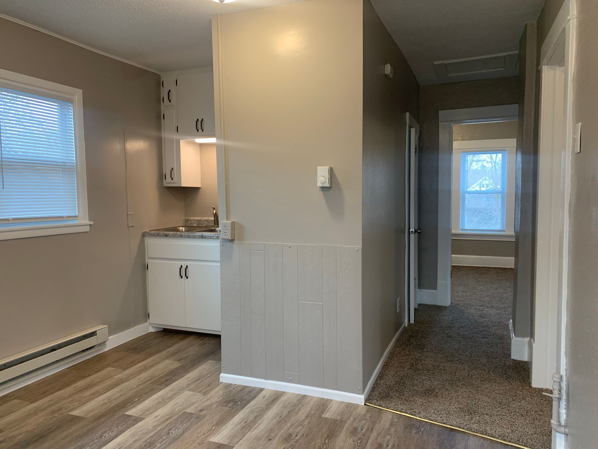 There is a kitchen in the middle of the room.
