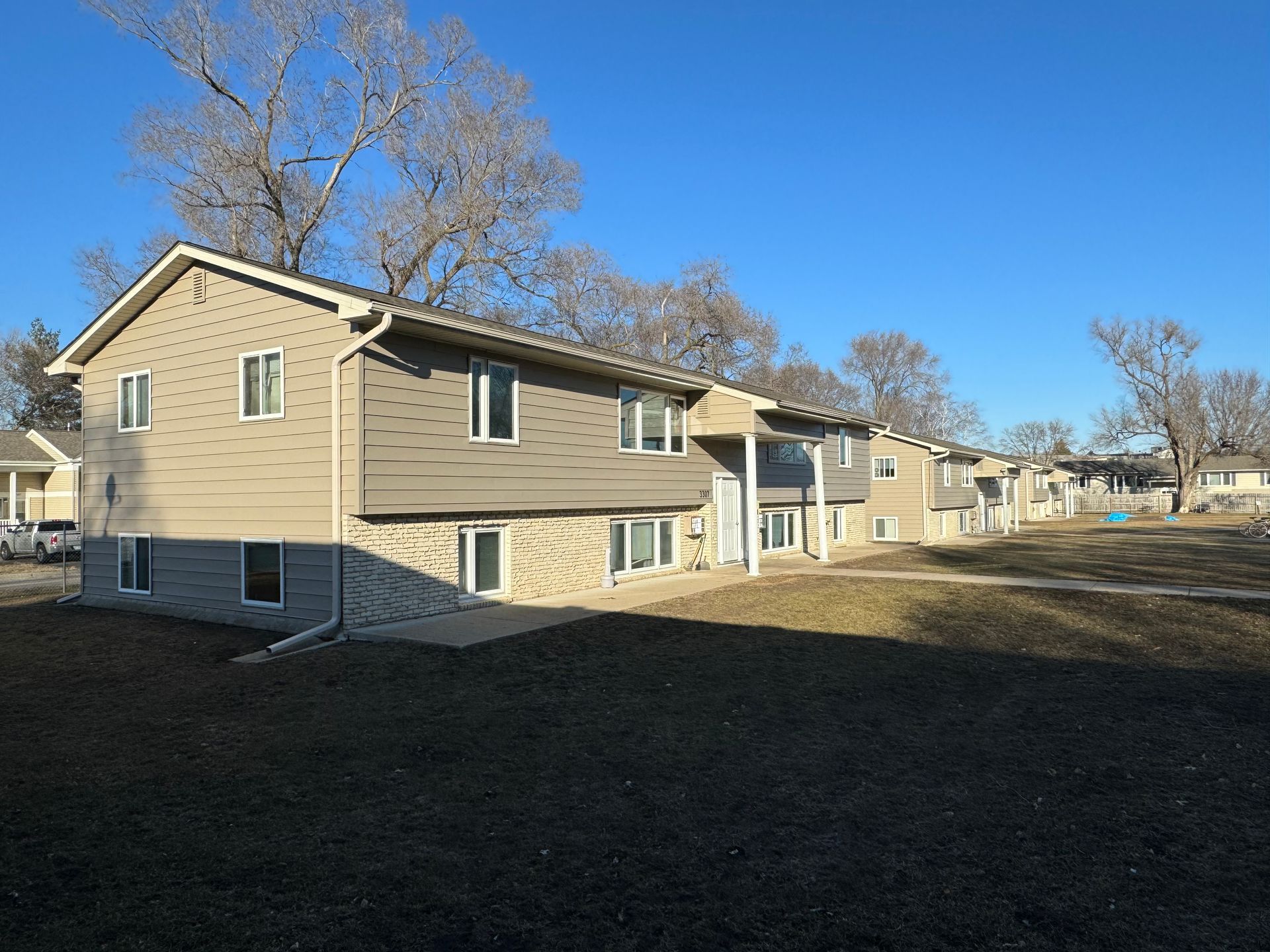 A row of houses with a blue sky in the background