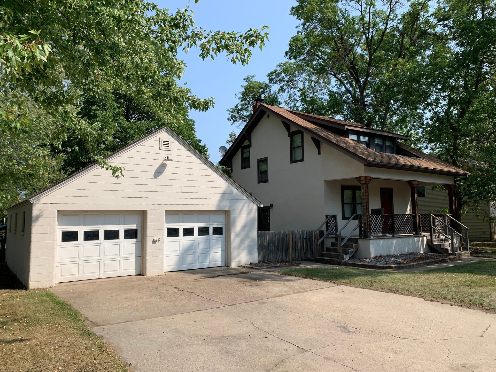 A white house with a garage next to it