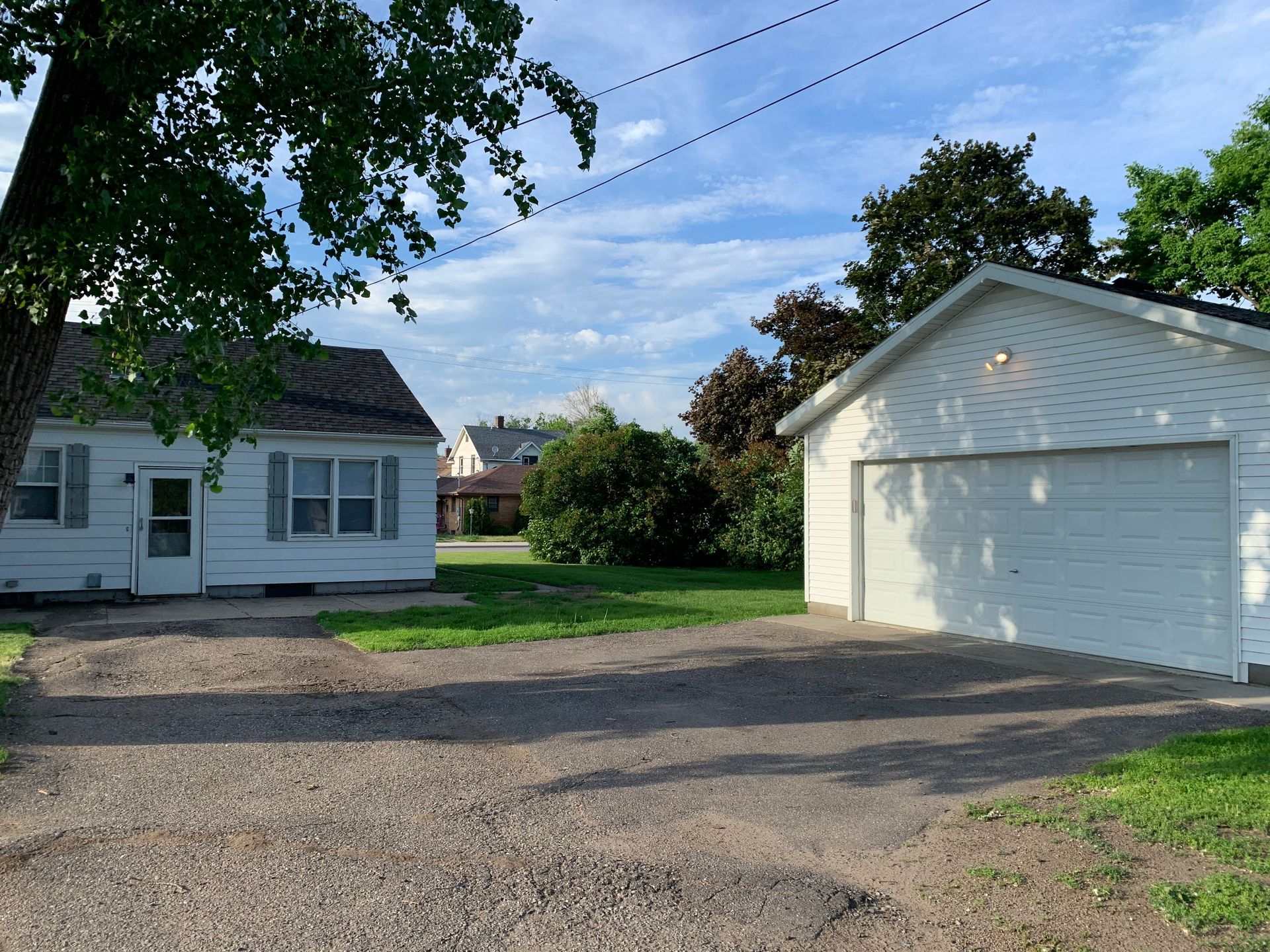 A white house with a garage next to it