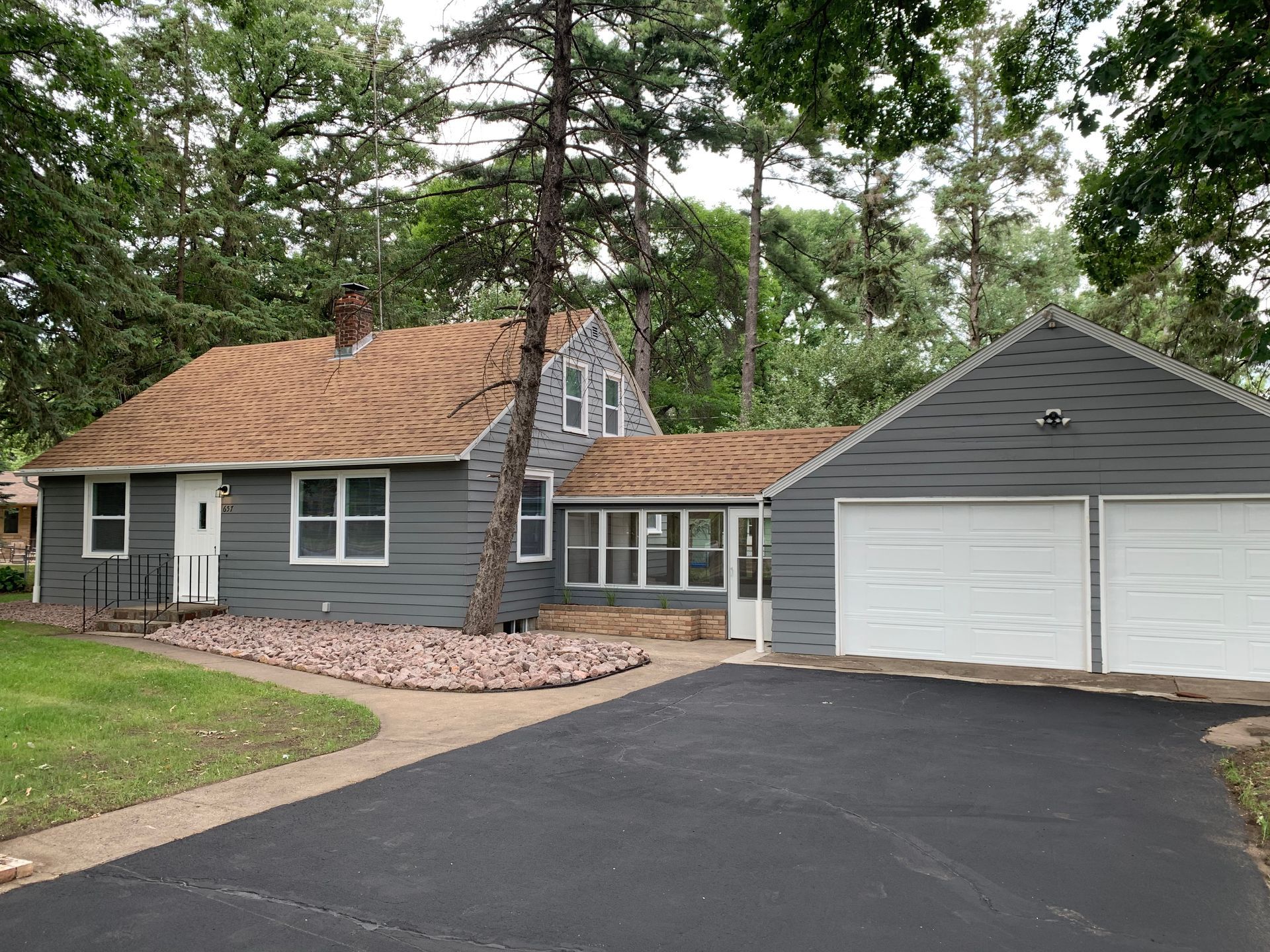 A house with a garage and a driveway in front of it