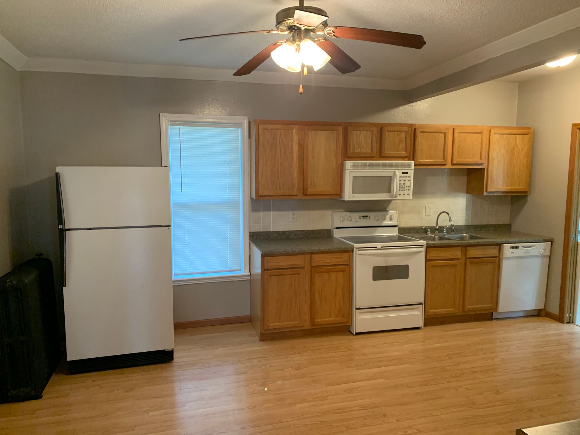 A kitchen with a refrigerator , stove , microwave and dishwasher.