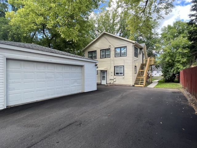 A house with a garage and stairs in front of it.