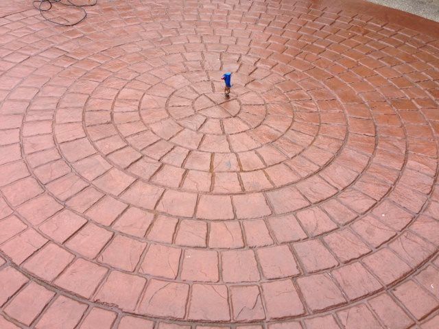 Decorative concrete surface featuring concentric stamped layout