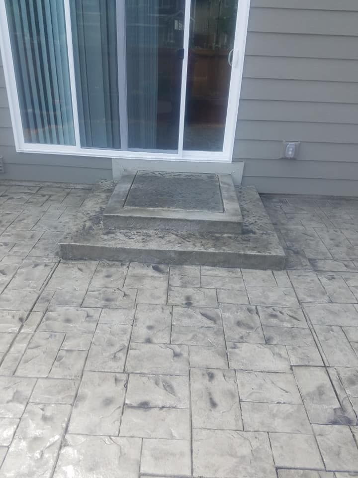 Decorative patio slab leading to sliding glass door