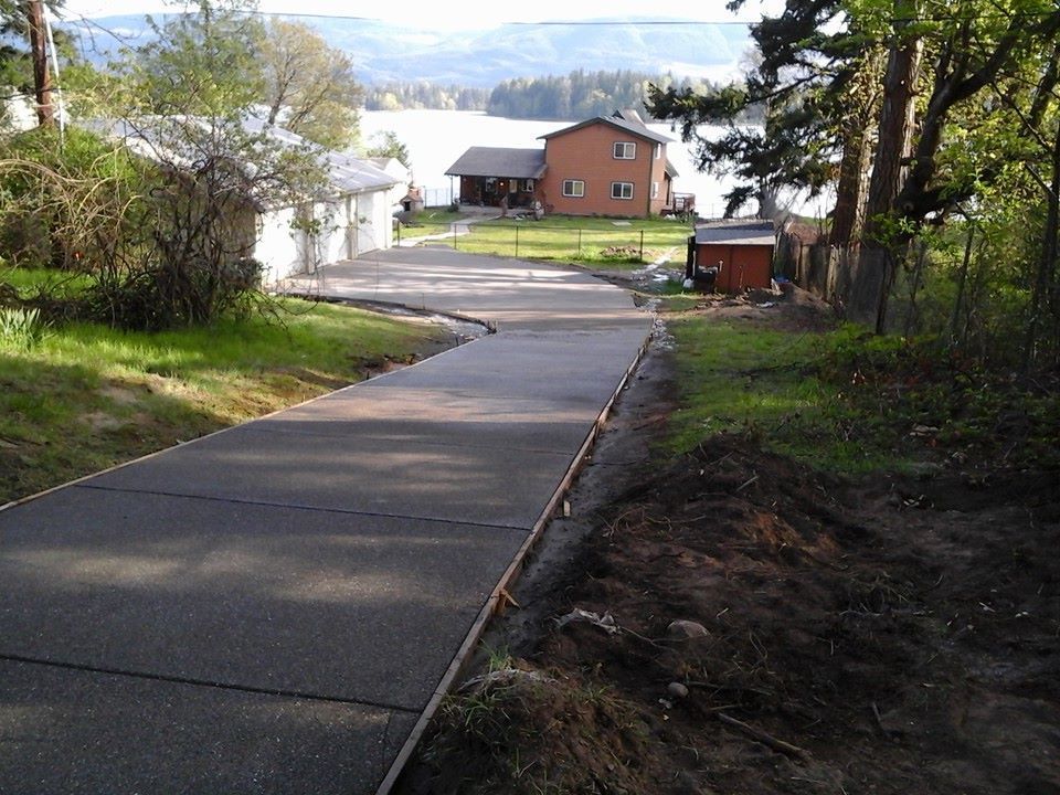 Extended driveway section leading toward lakeside home