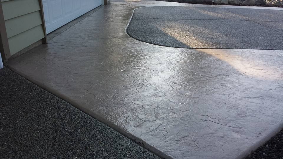 Stained wrap with stamp texture around an aggregate driveway