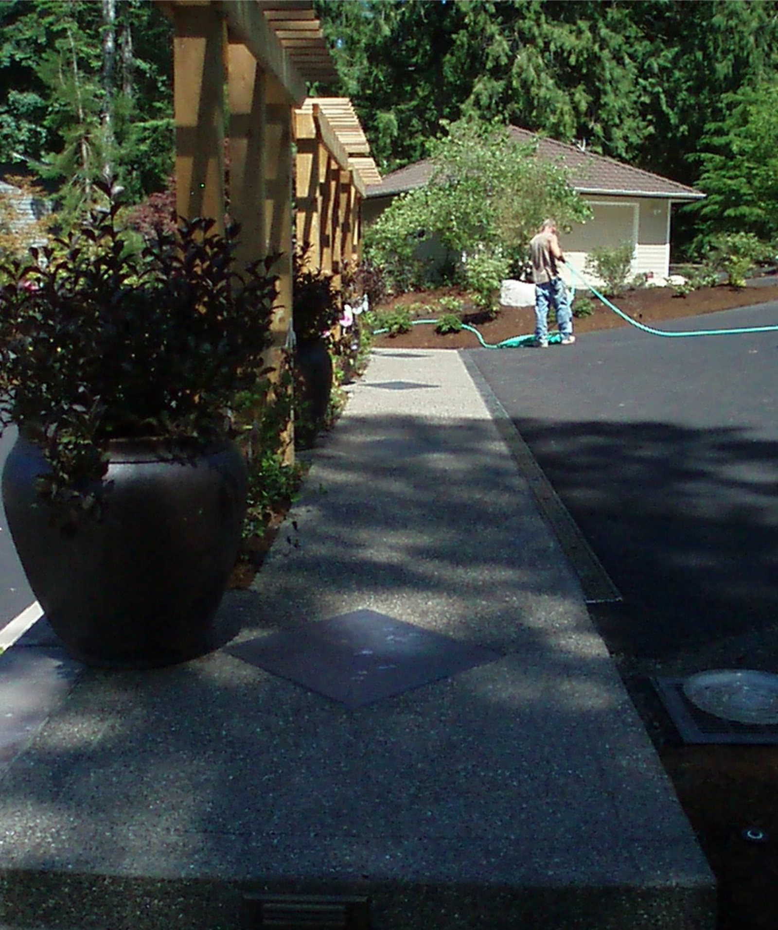 Decorative exposed aggregate driveway bordered by landscaped steps