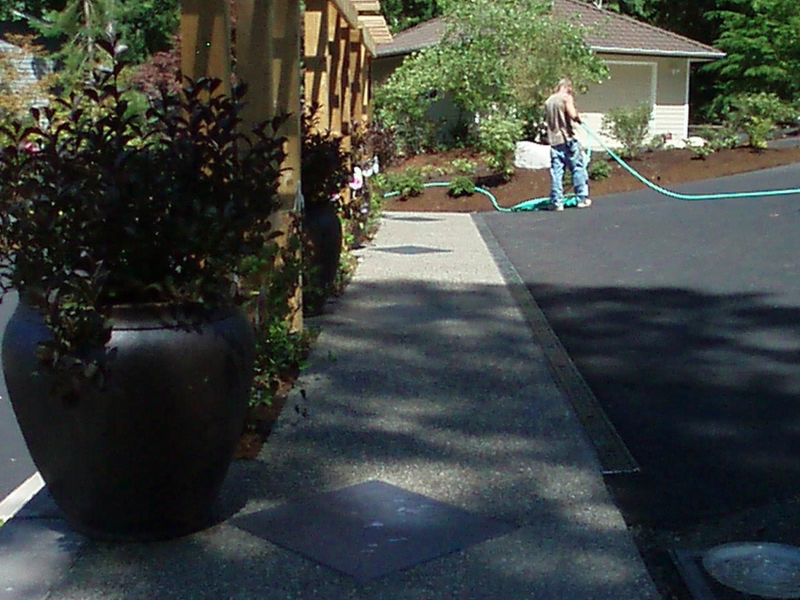 Concrete driveway renovation with surrounding hardscape