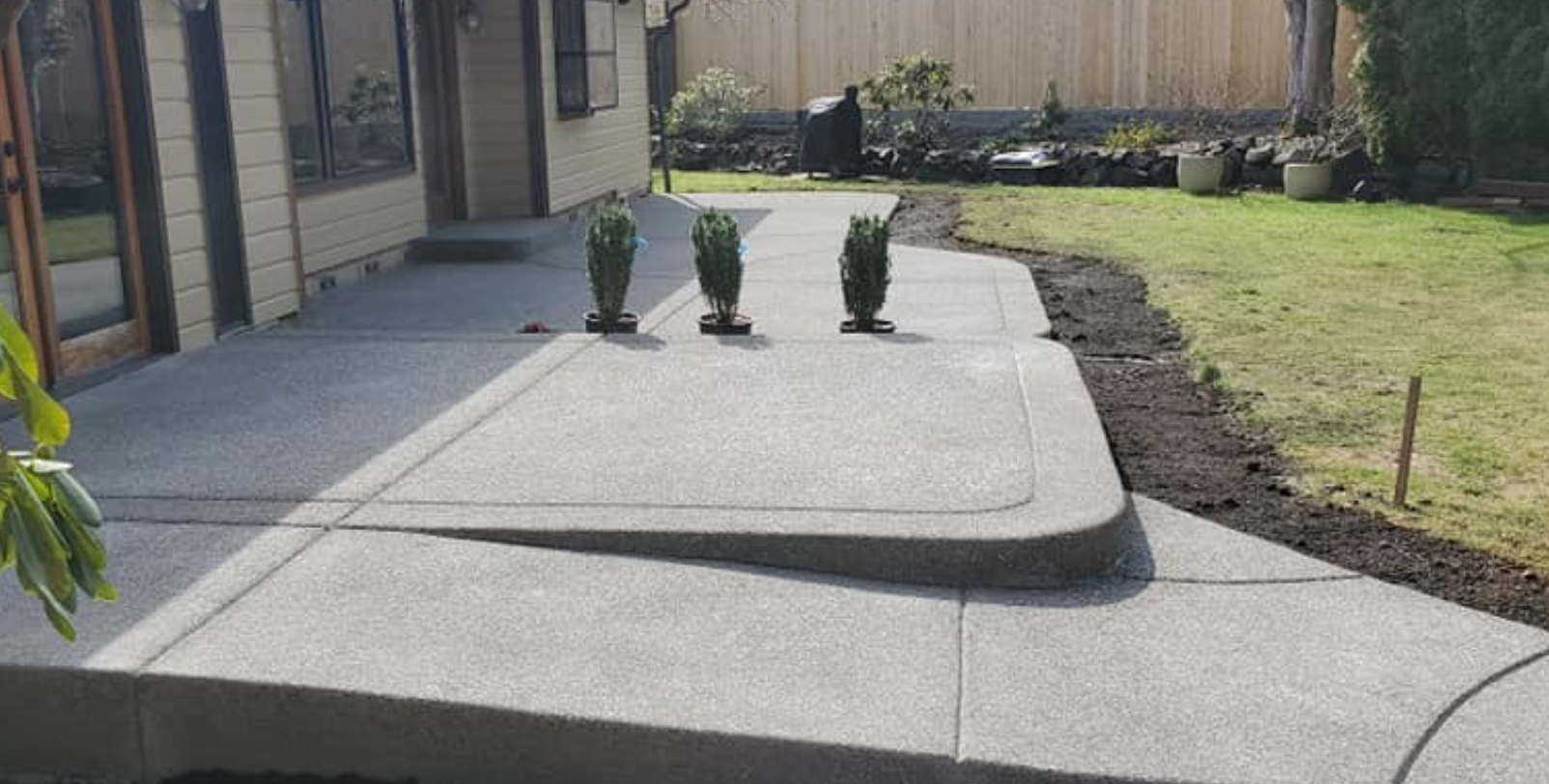 Residential backyard patio installation with curved step detail