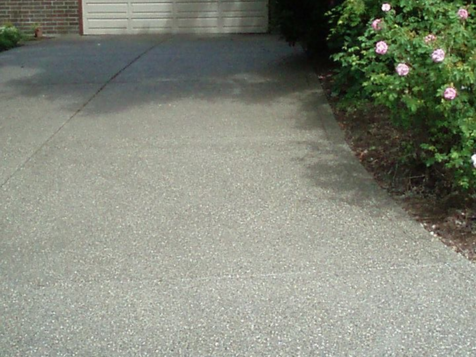 Exposed aggregate concrete driveway with pebble finish texture