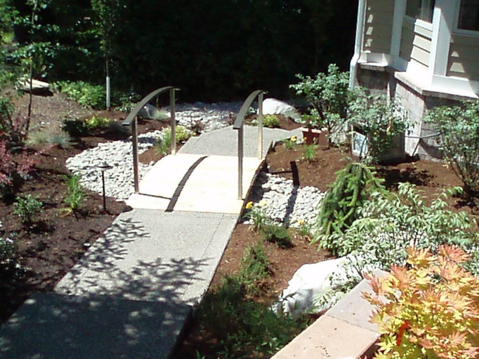 Exposed aggregate concrete walkway with landscape integration