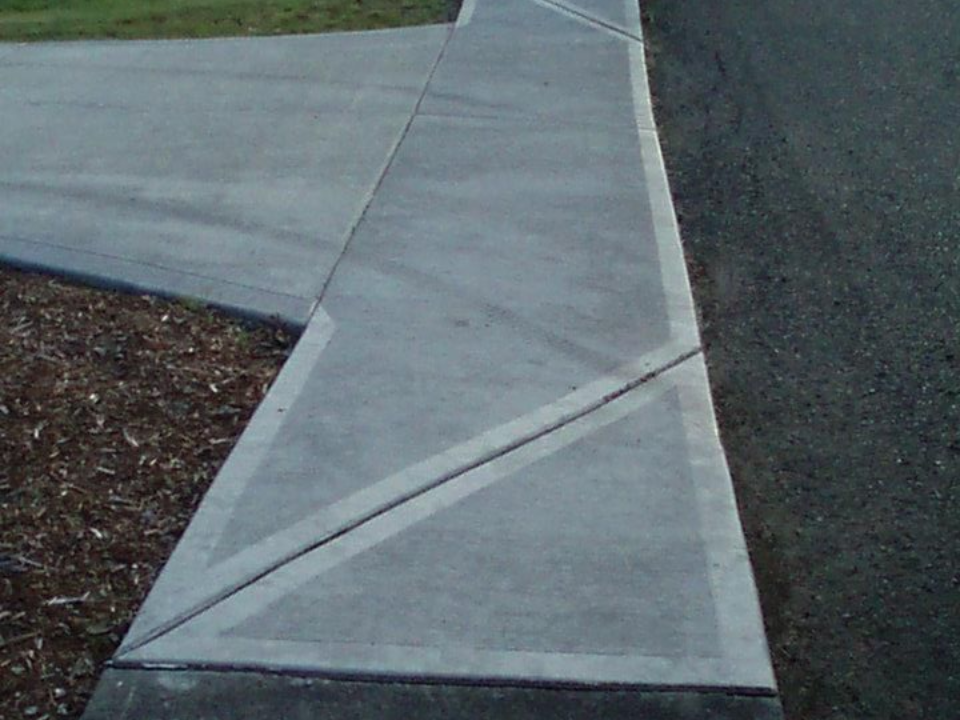 Curved concrete sidewalk with decorative scoring