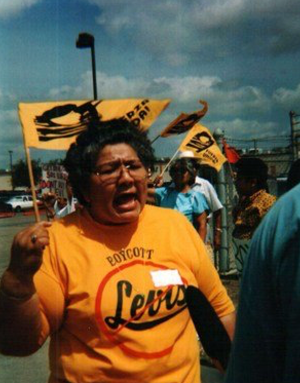 A woman wearing a yellow shirt that says levi 's