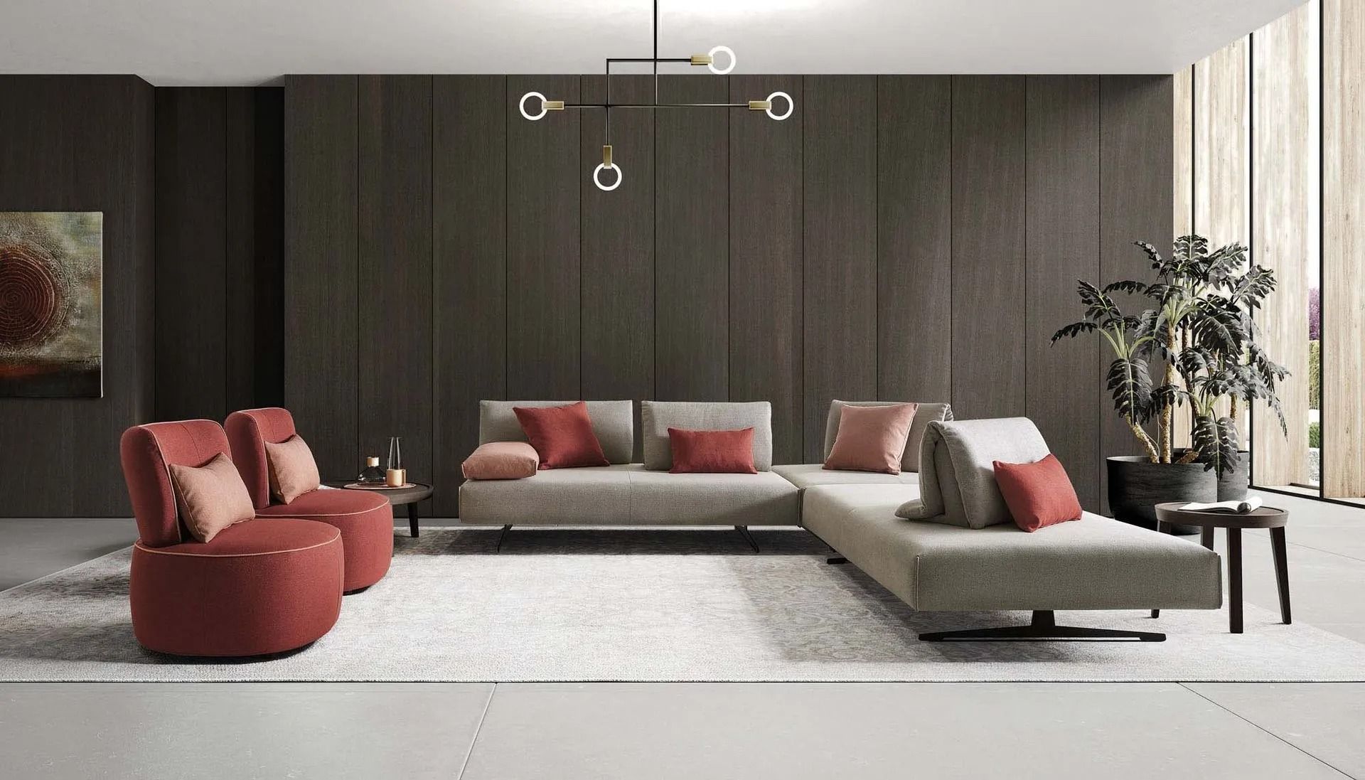 Soggiorno moderno con divani rossi e grigi, parete in legno scuro e lampada a sospensione minimalista.