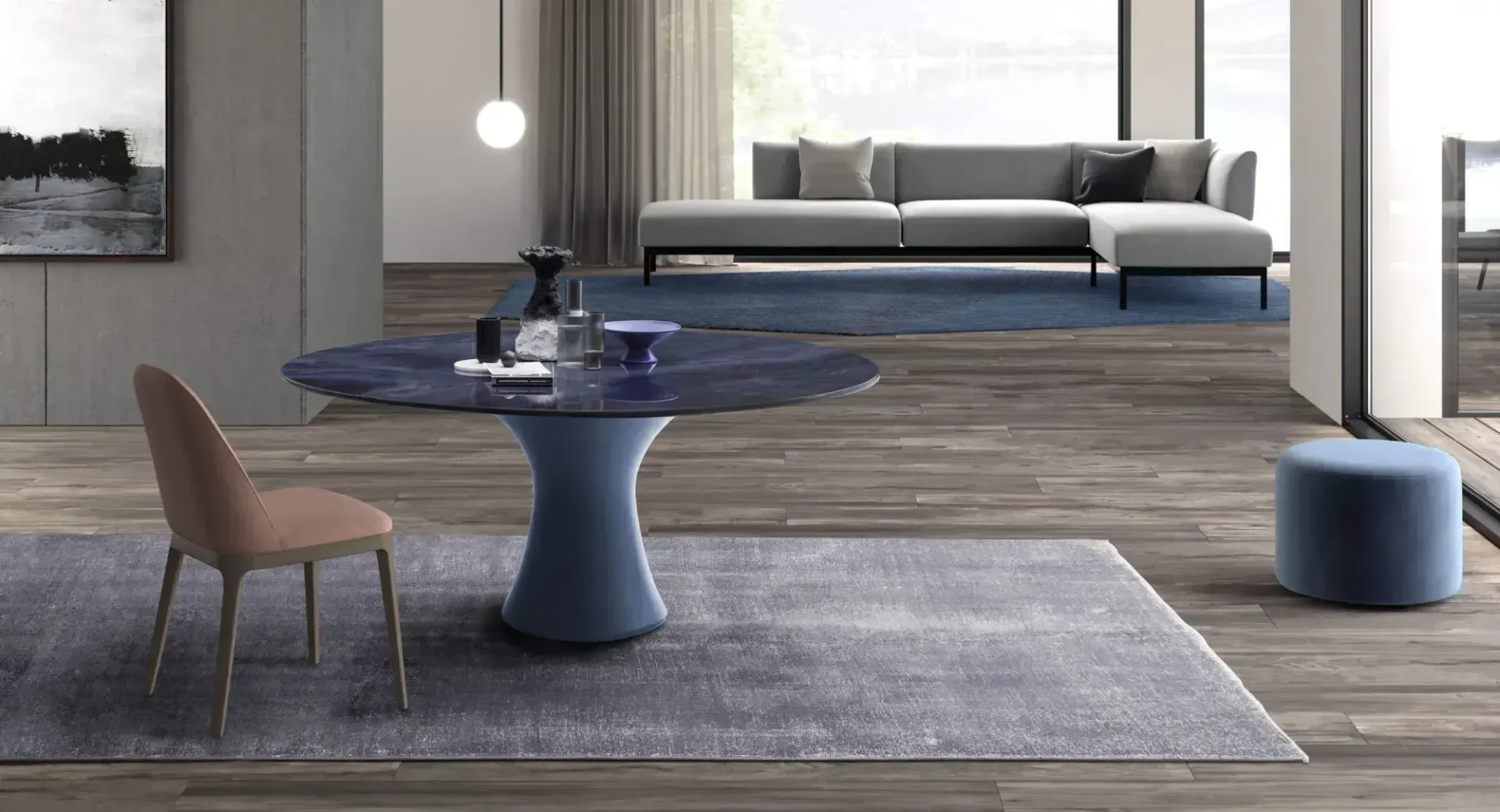 Soggiorno moderno con tavolo rotondo blu, sedia beige, tappeto, divano e pouf vicino a una finestra.
