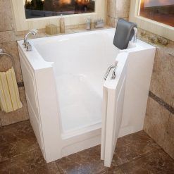 A walk in tub with a door open in a bathroom.