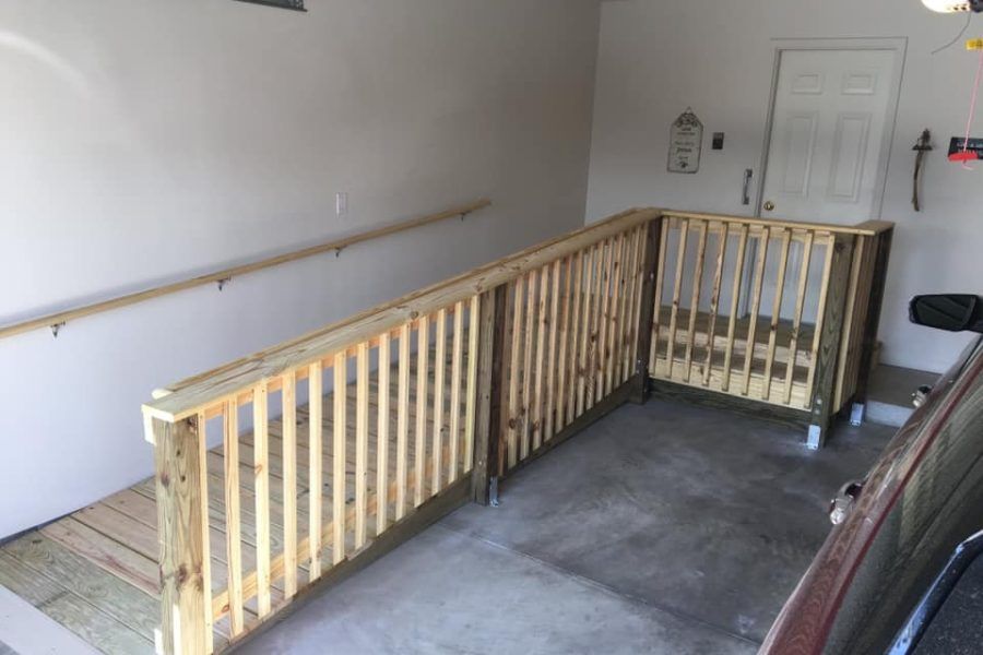Custom wooden wheelchair ramp with handrails built by CraftMaster in Knoxville TN